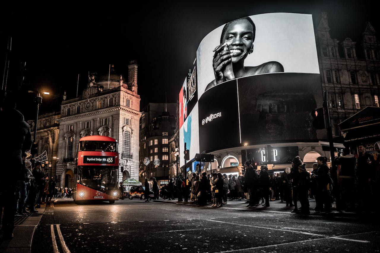 Crafting Captivating Headlines: Your awesome post title goes here Vibrant city life at night in Piccadilly Circus, London with double-decker bus and illuminated billboards.